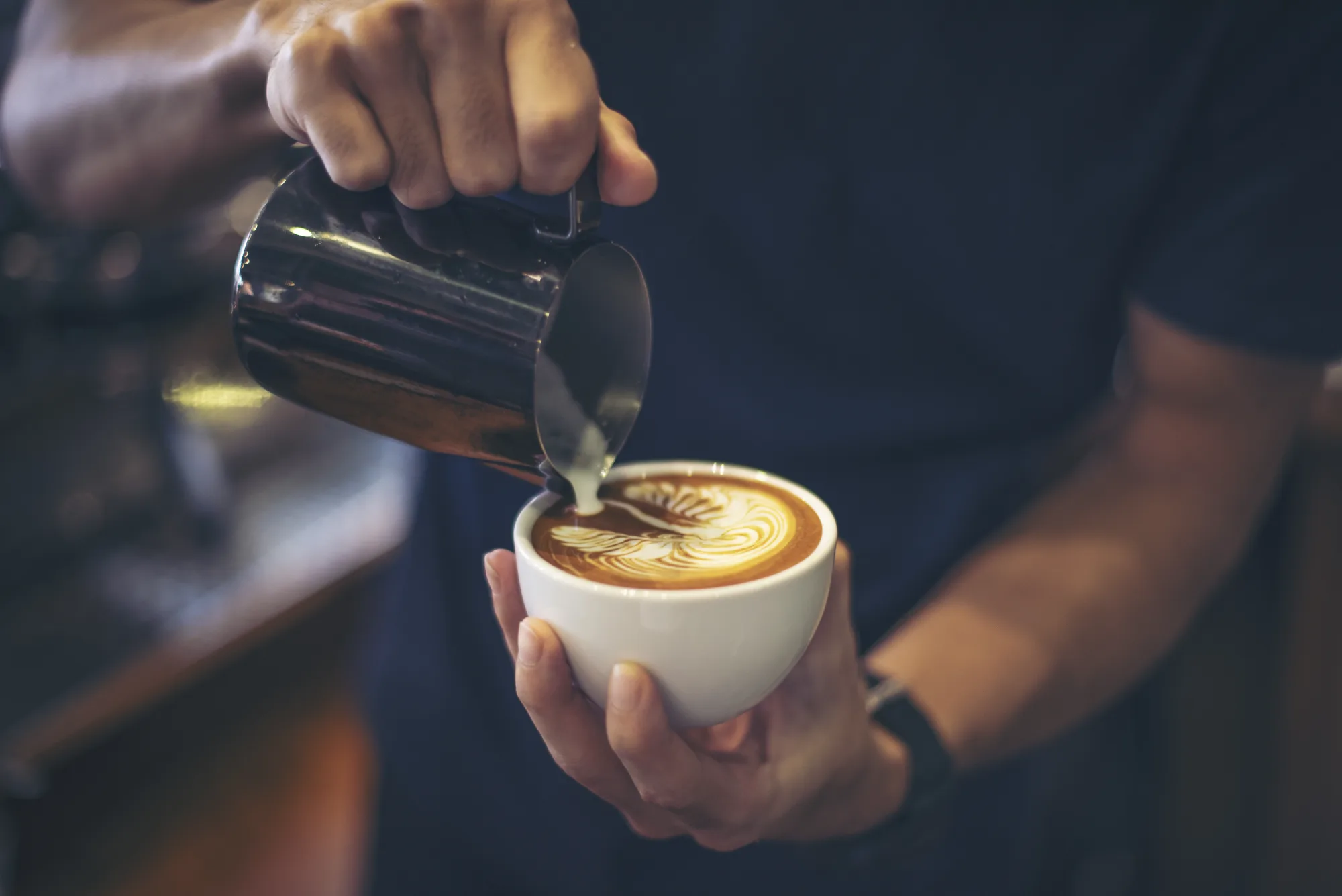 Professional barista preparing coffee at an event